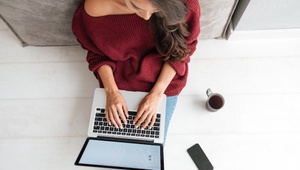 woman on laptop with cup of coffee