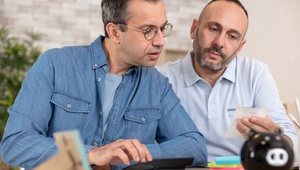 male couple looking at finances