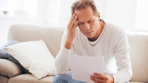 worried man holding a letter