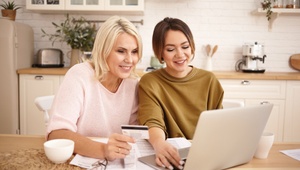mother and daughter shopping online with credit card