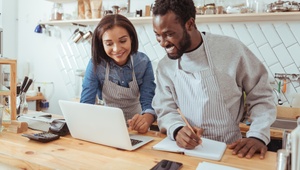 self employed couple looking at laptop