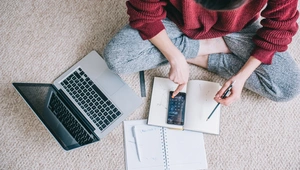 Overhead view of young brunette woman using laptop