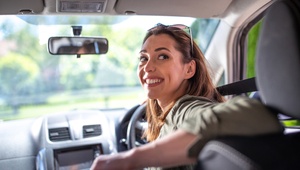 smiling woman in car
