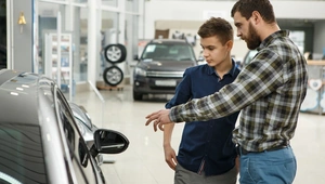 boy buying car with dad