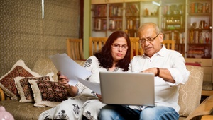 couple looking at laptop in living room