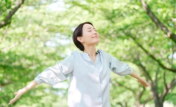 Woman in woods breathing