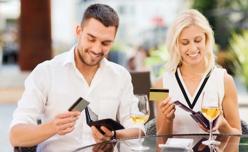 Man and woman looking at their bank cards