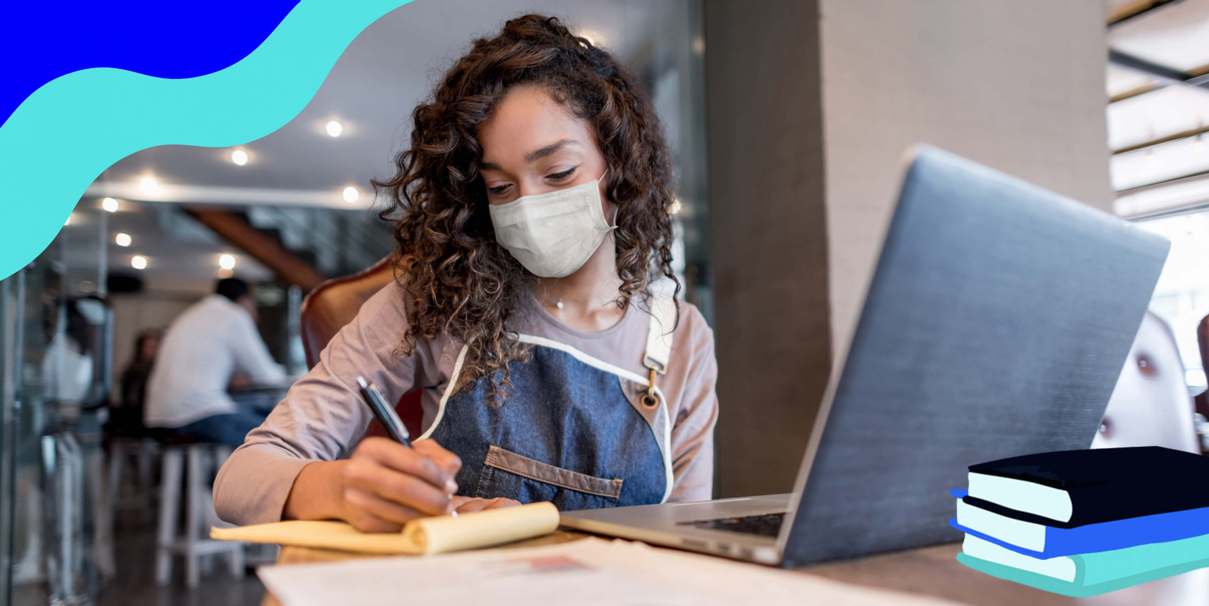 woman with mask on taking notes in front of a laptop