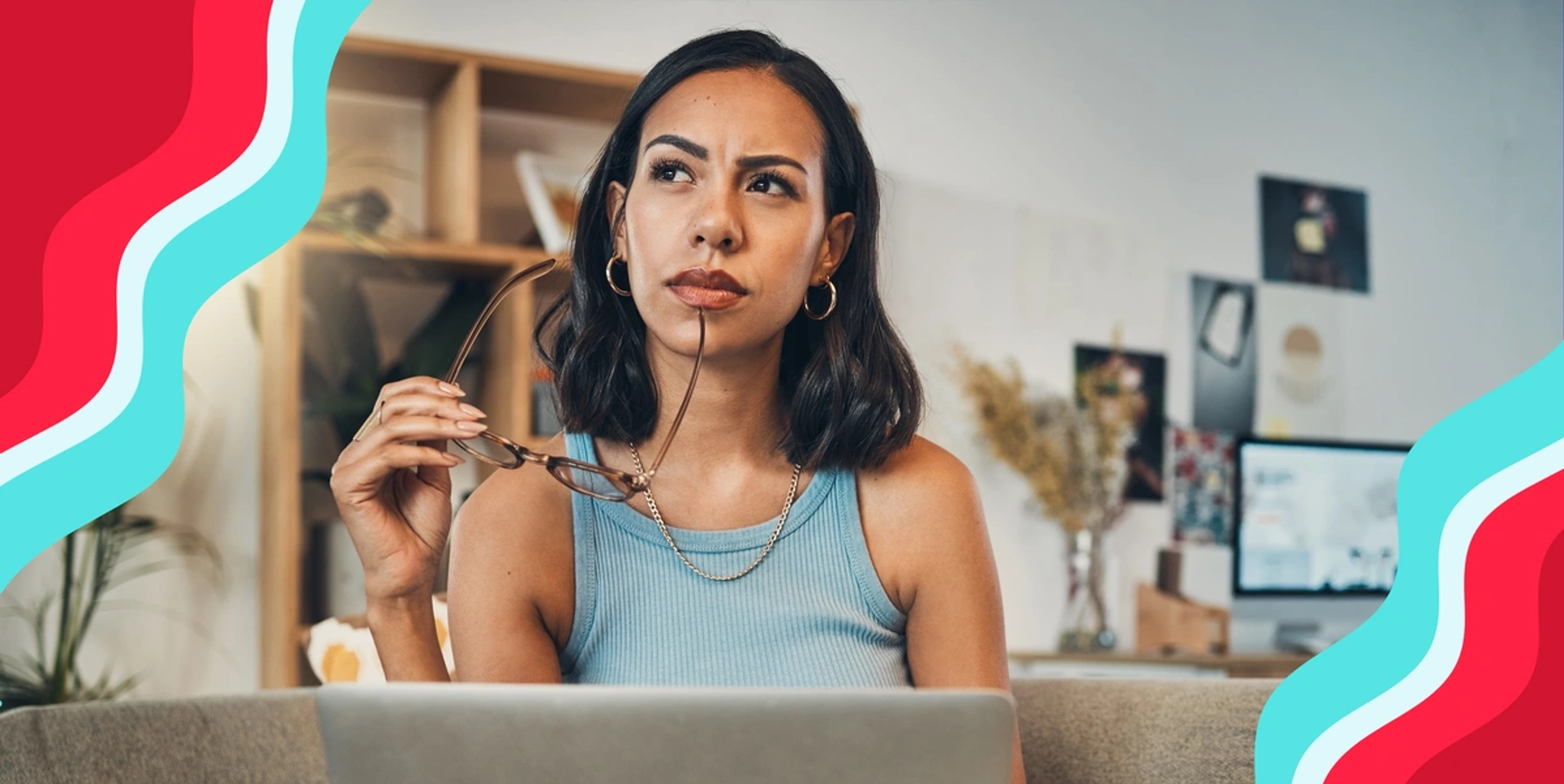 woman looking into the distance with glasses in her hand lightly pressed against her face