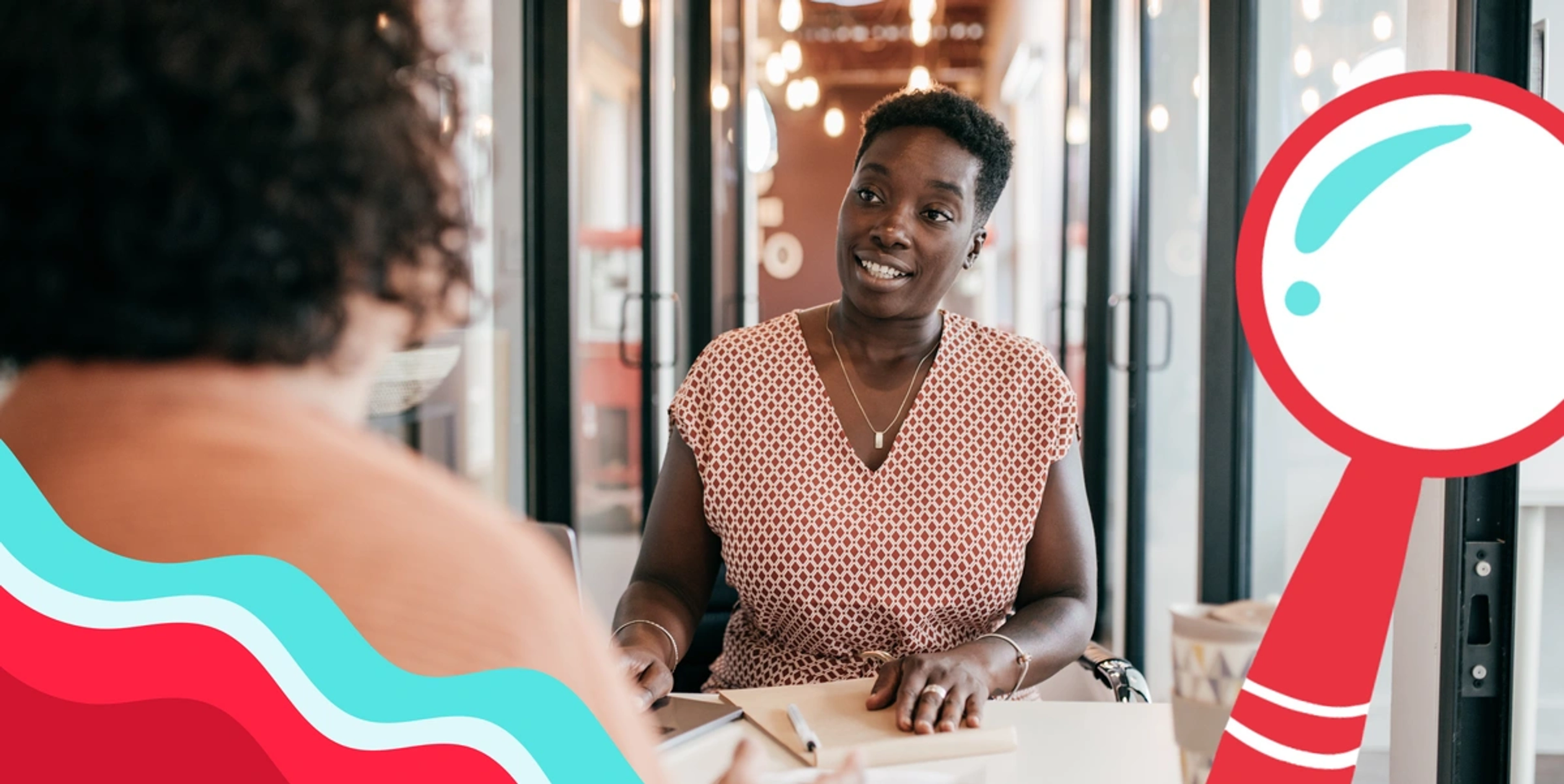 Featured Image: black woman sitting in a common workspace like a wework, talking to another woman, framed by a red magnifying glass