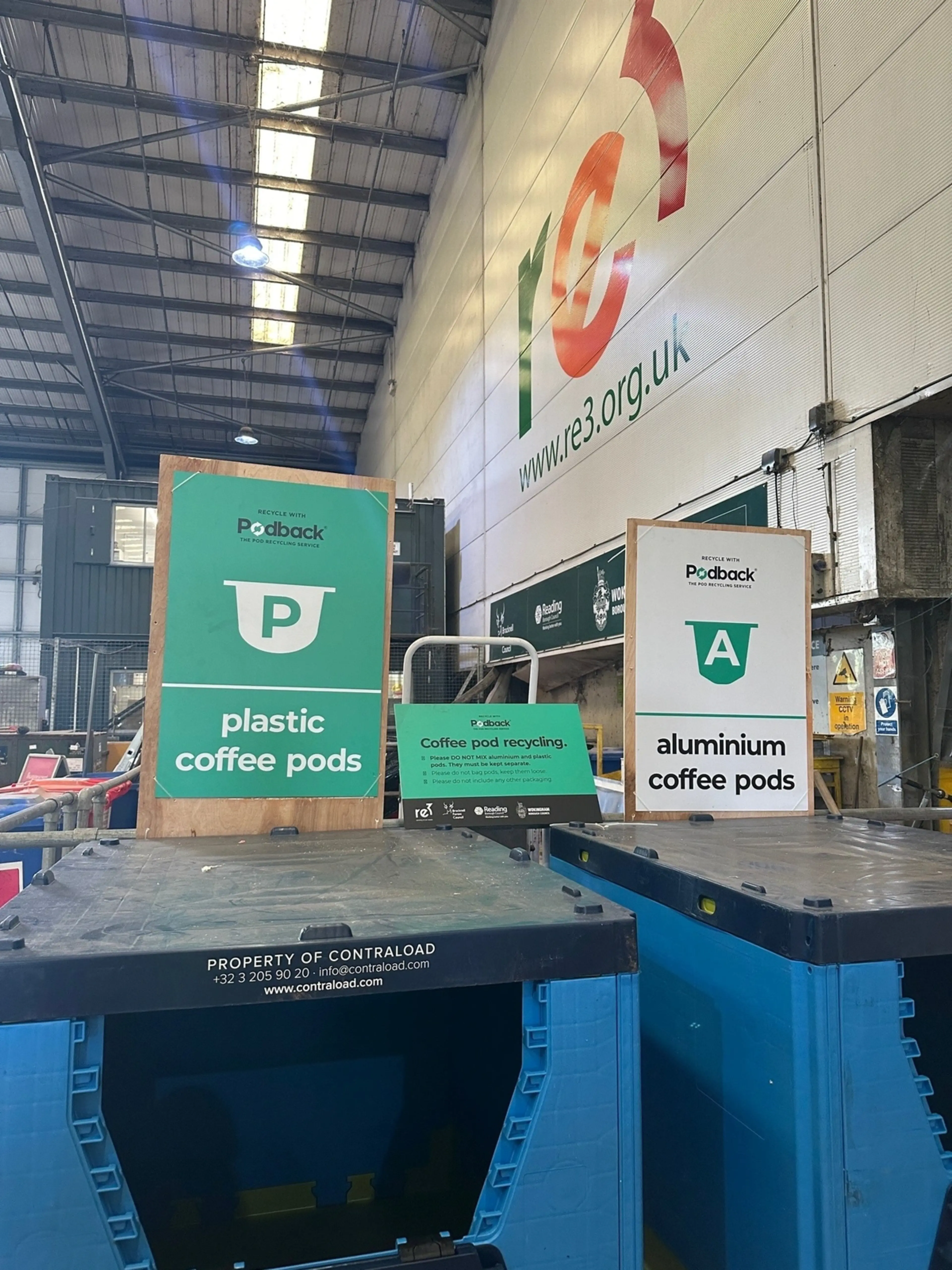 Pallet box containers for recycling used plastic and aluminium coffee pods at a recycling centre.