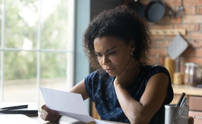 Woman reading letter from a debt collection agency