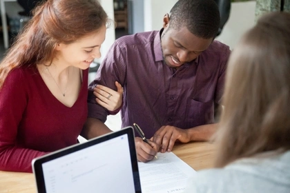 couple signing agreement at bank