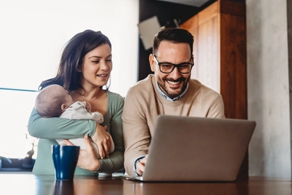 Couple at computer with baby applying for a loan