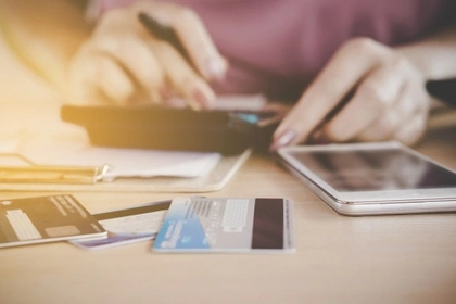 woman with calculator and credit cards