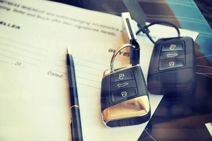 two sets of car keys and a contract