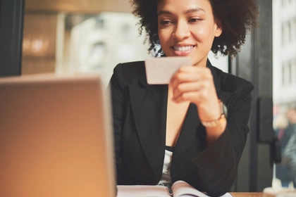 woman with a credit card at a desk
