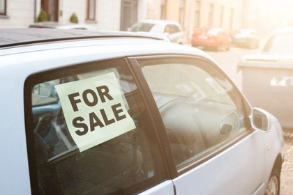 car with for sale sign in the window