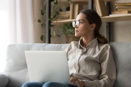 woman on laptop thinking