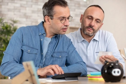 male couple looking at finances