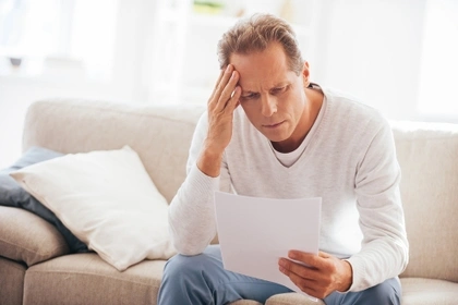 worried man holding a letter