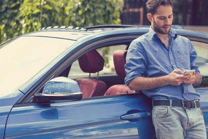 man leaning on car