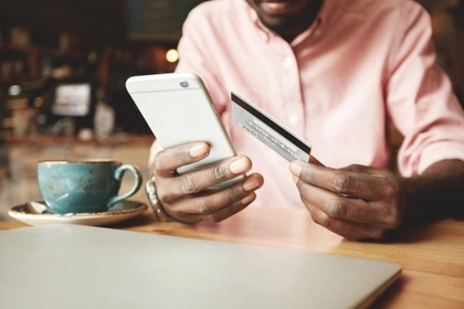 man on phone with credit card