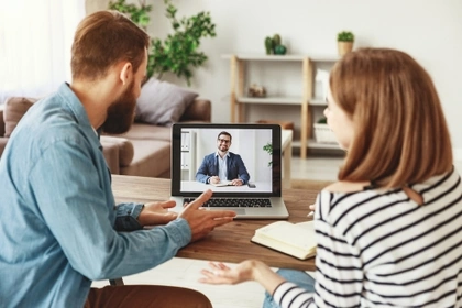 couple speaking to financial adviser over internet