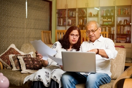 couple looking at laptop in living room