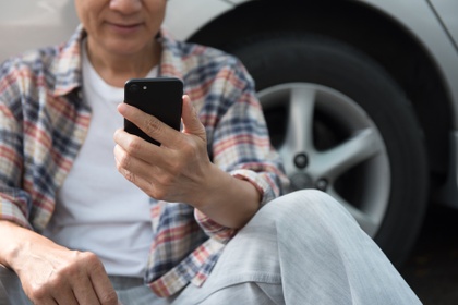 Man on phone outside car