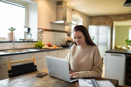 Woman on her laptop in the kitchen