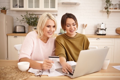 mother and daughter shopping online with credit card