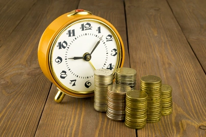 Clock with money next to it