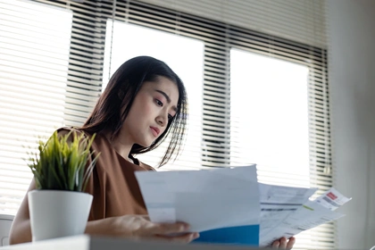 Woman looking over paperwork