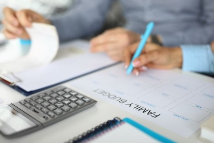 A person filling in a family budget