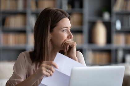 worried woman holding letter