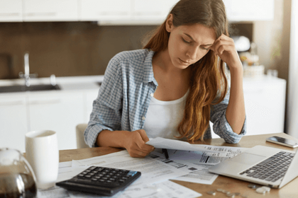 Woman looking through her bills