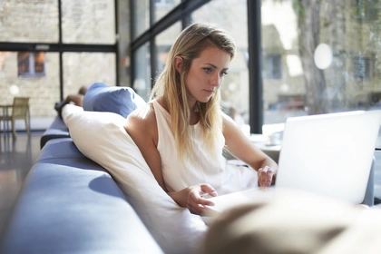 Young woman looking at her laptop 