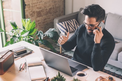 man on mobile at desk