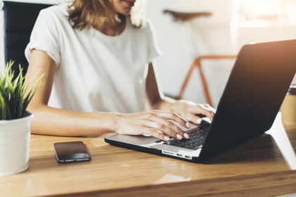 Woman typing on laptop