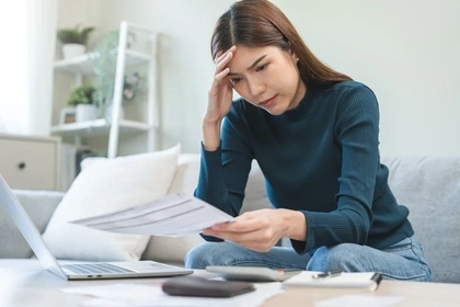 Woman reading her credit card statement