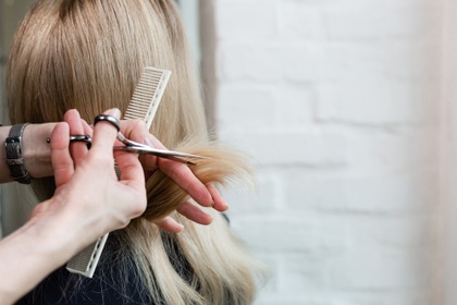 woman getting hair cut at hairdressers