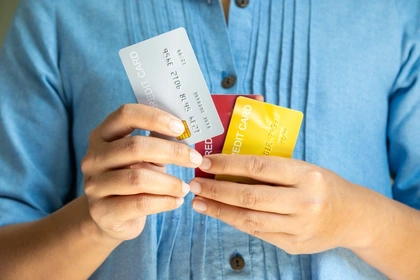 Close up of a person holding different types of credit and debit cards