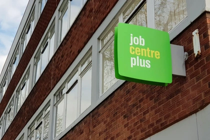 woman looking at coins left in purse