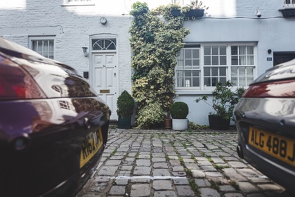 two cars outside a home