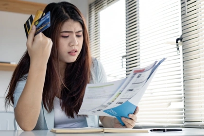 Woman contemplating her bills