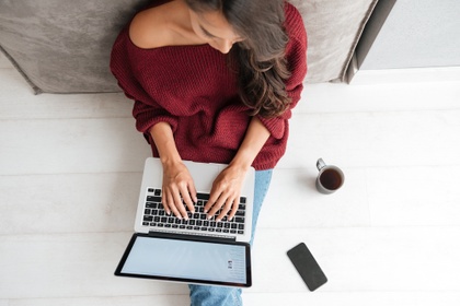woman on laptop with cup of coffee