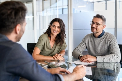 Couple discussing a loan with an adviser.