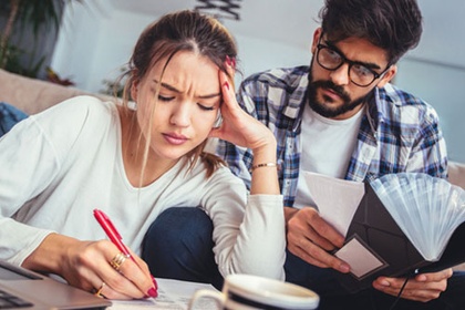 Man and woman looking through finances 