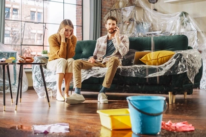 Couple in room with leaking ceiling